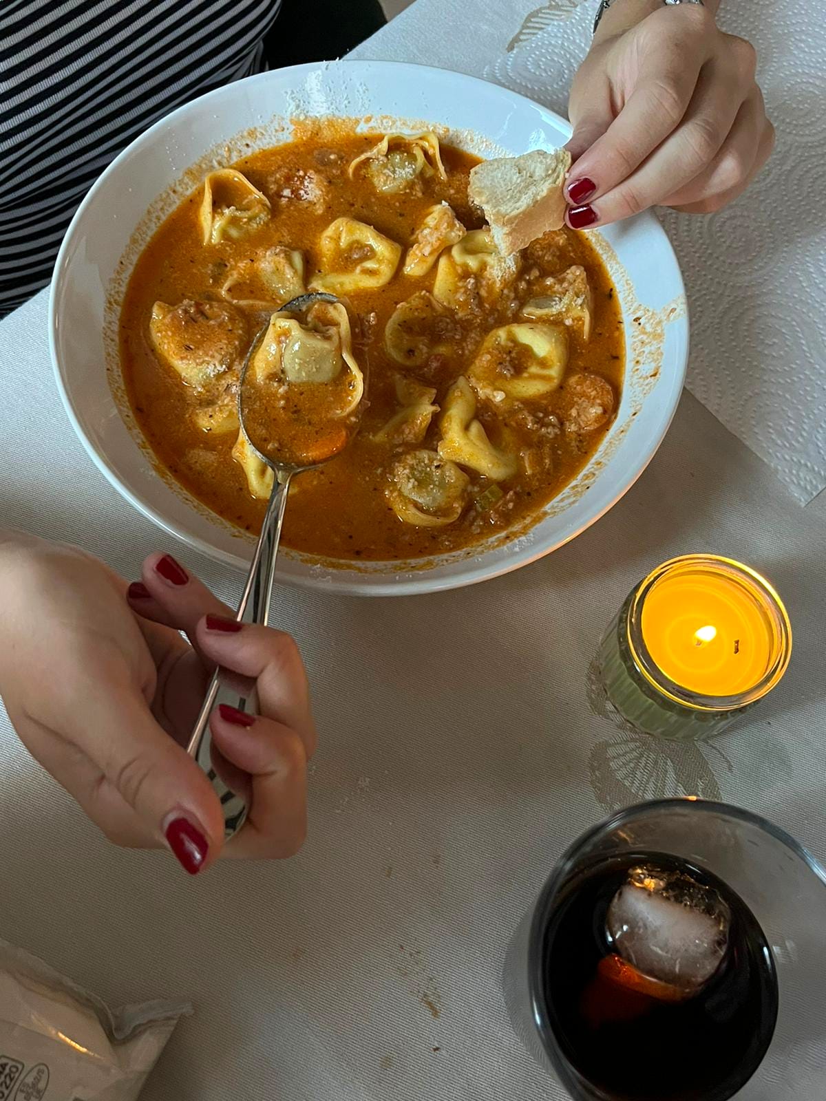 Tortellini in tomato broth by candlelight, bread dipped in the bowl